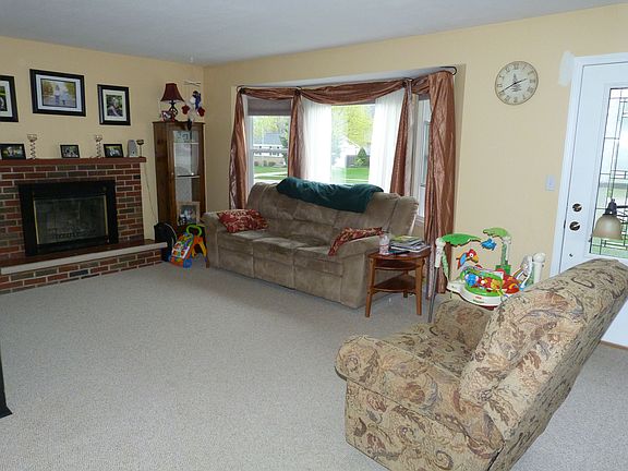 gorgeous bay window and rich wood burning fireplace