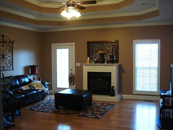 Living room w/ double trey ceiling and hardwood flooring
