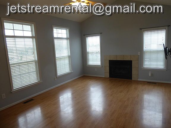 Living room with gas logs and transom windows