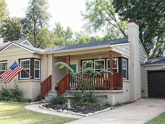 The richly stained porch railings and vivid front door add great contrast to the neutral tones of the home. What great curb appeal!