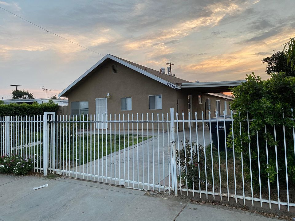 Gated front and side yard with carport