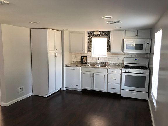 Although not pictured, there is a white refrigerator next to the cabinets on the left.