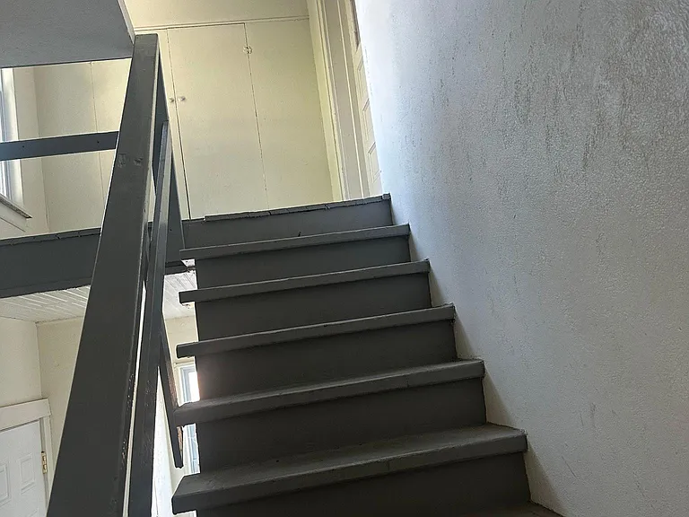 Steps up. Closet at the top of the steps plus additional storage. Bike hooks.