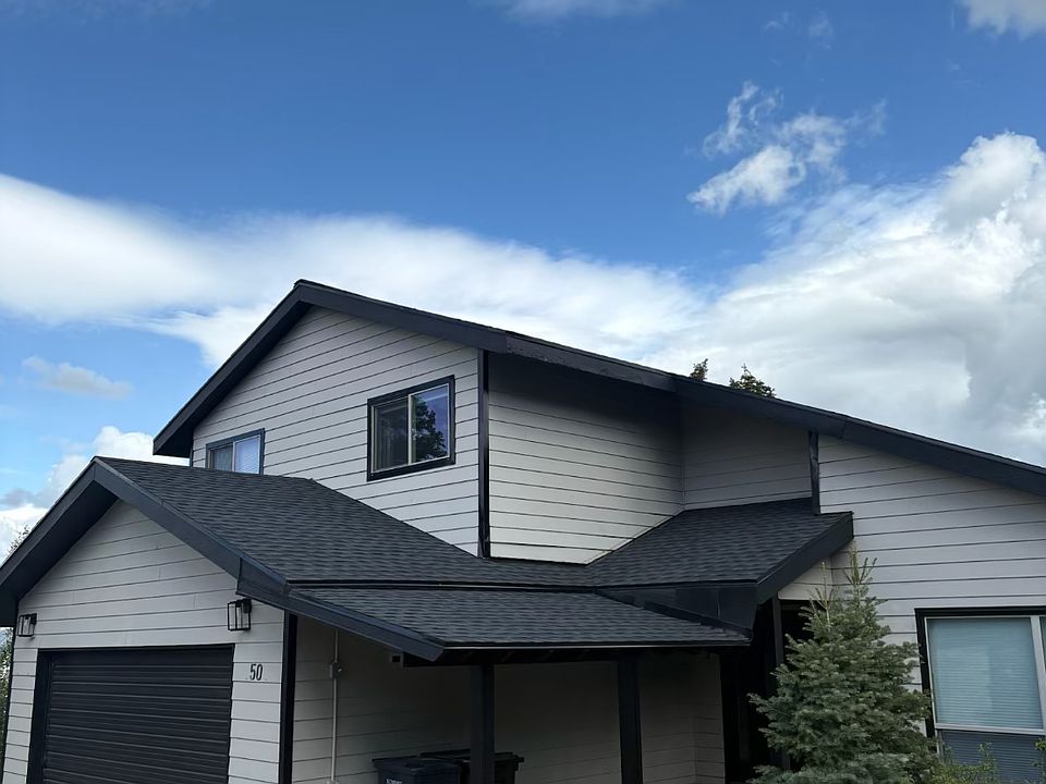 Exterior of home. Park off street on a gravel area. Entrance to the ground level of property is on the flagstone walkway, around the right side of the home.
