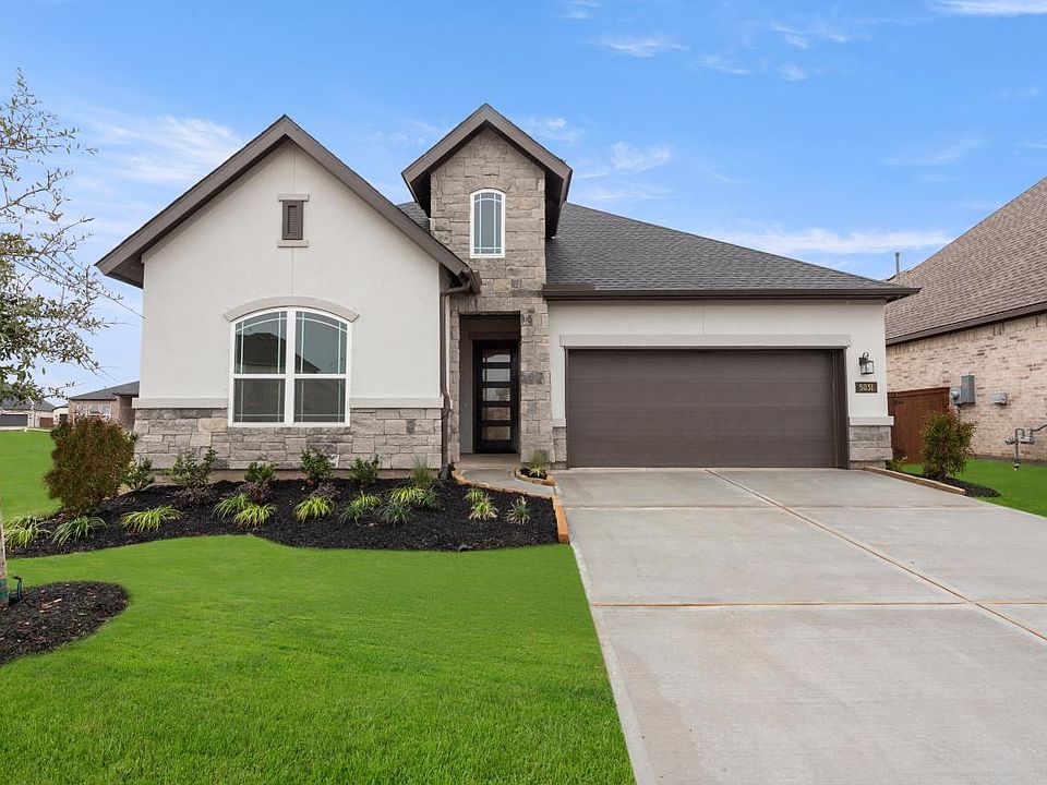Sleek stucco and stone exterior with full landscaping