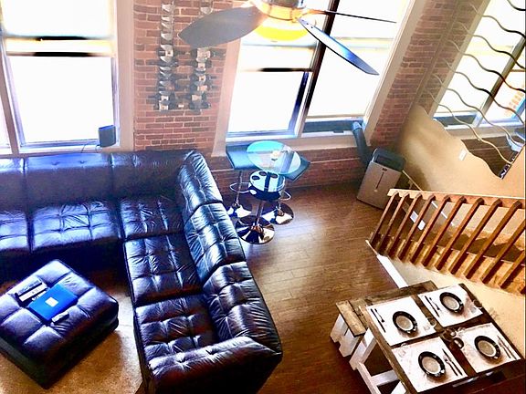 View from upstairs loft w/ queen bed and connected half bath