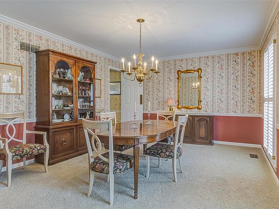 Large dining room for entertaining with crown molding and chair rail