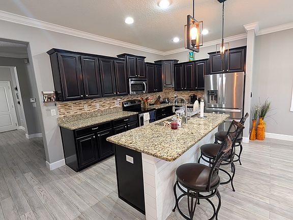 large kitchen area with walking pantry.