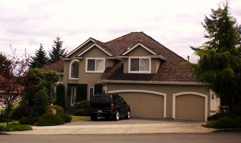 Front of house has paved walk way to lower living area.