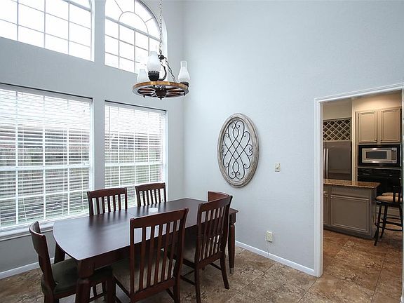 Here in this dining area are another set of large arched windows that add such airiness and spaciousness to this home!
