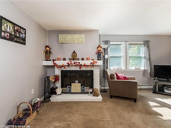 Large family room with wood burning fireplace.
