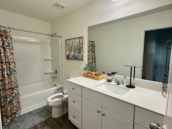 Shared upstairs bathroom with tub/shower combo and vanity