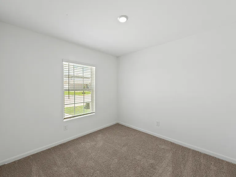 Second bedroom with lush carpet.
