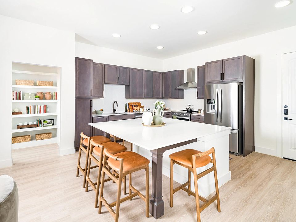 Gather with ease in Modera Trailhead's gourmet kitchens, featuring expansive islands, sleek cabinetry, and stainless-steel appliances.