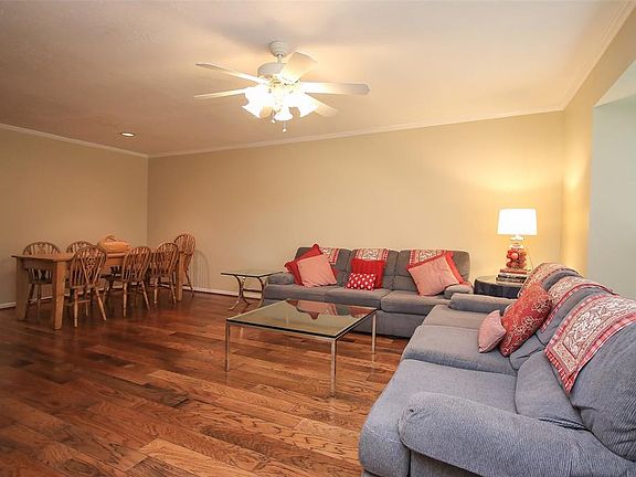 Spacious living room with hardwood floors and crown molding