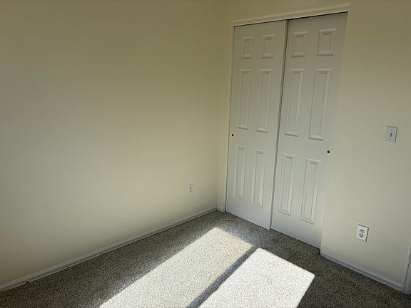 smaller 9x10 bedroom and closet with views of Pikes Peak.