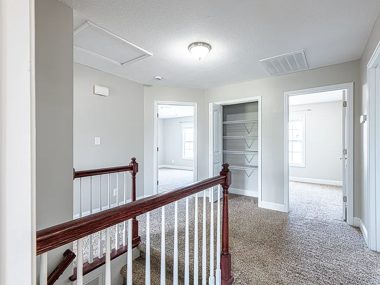 Upstairs landing providing access to all upper-level rooms and a closet for additional storage