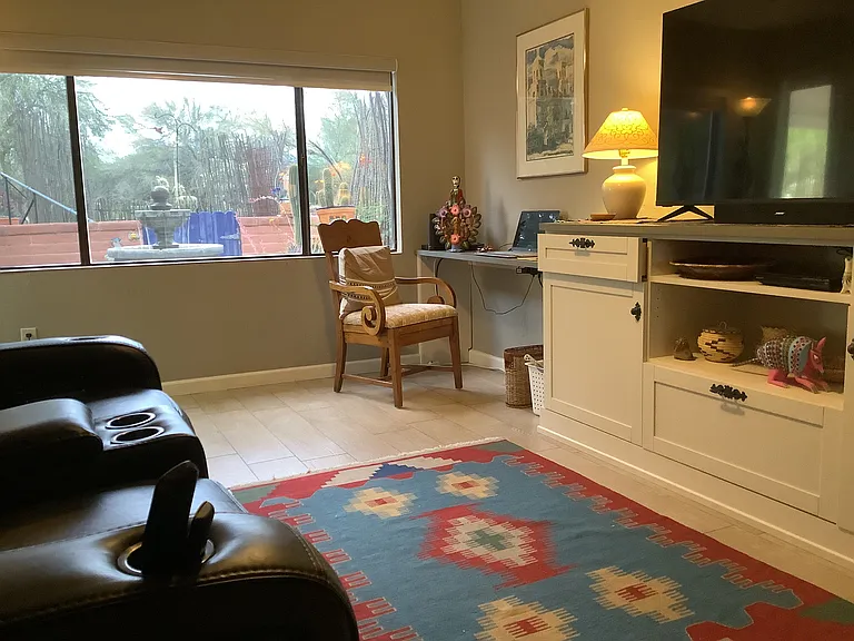 The second living space with its double recliner and large TV also includes a workspace, wireless printer and everyday office supplies all neatly tucked away.