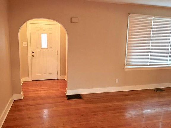 View of front entrance and living room with hardwood floors.