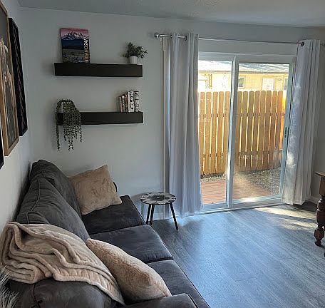 LIVING ROOM AND SLIDING GLASS DOOR TO PRIVATE DECK