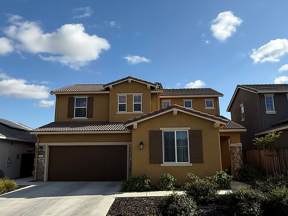 Front of home, drive way and 2 car garage