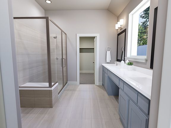 A modern and minimalist bathroom with a glass shower enclosure, a vanity with drawers, and a window