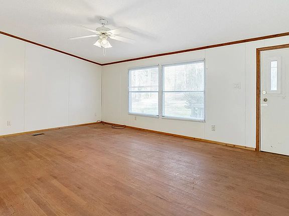 front door, living room. door to main suite on the left