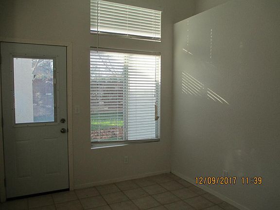sunny kitchen with door to backyard