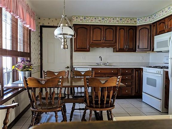 The eat in kitchen has access to the attached garage and the screened porch.