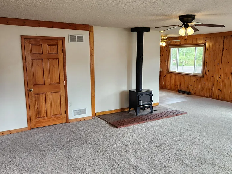 Wood burning stove and door to half bath