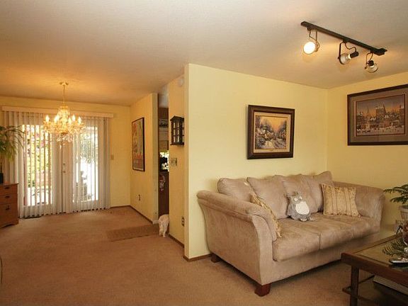 View from the living room to the formal dining room with French doors leading to deck.