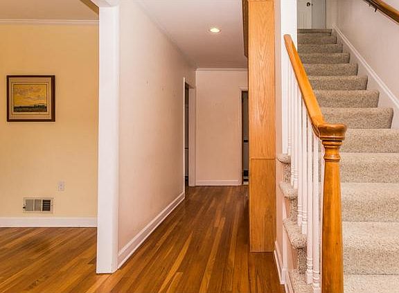 Spacious entry hall has hardwood floors