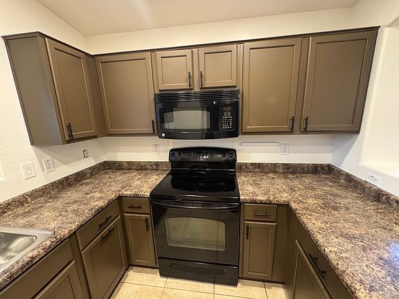 Updated kitchen with ample cabinet space, matching appliances, and breakfast bar