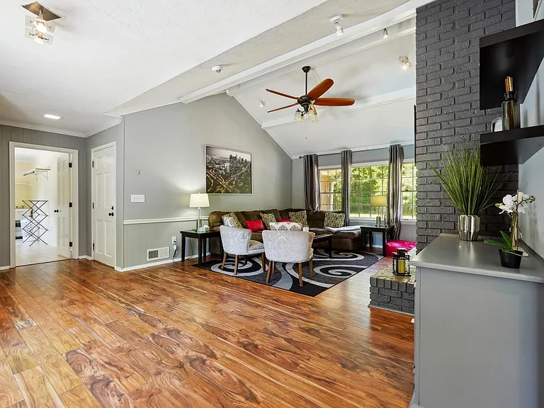 Living Room with TV, Fireplace & access to Garage & Upper Back Patio -Main Level