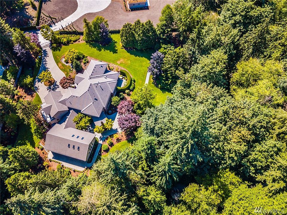 Distinguished Lake of the Woods property rests on a private 2.42 acres in a small cul-de-sac. A concrete paver stone path leads to the waterfall and sports court; explore the hidden trails in the woods.