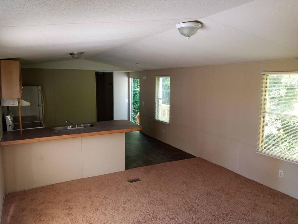 Living room.. door to rear.. windows with blinds