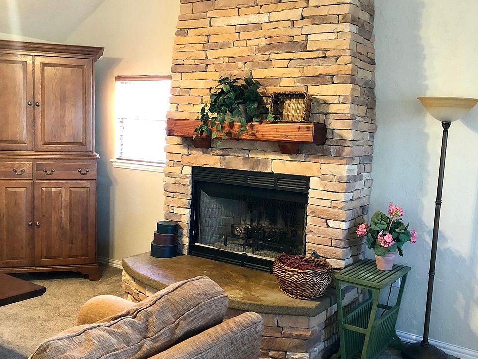 Open concept living with beautiful fireplace towering into vaulted ceilings.