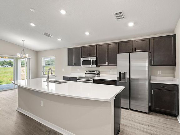 Your bright, open kitchen includes quartz, 36-inch cabinets, Samsung SS appliances, and a walk-in pa
