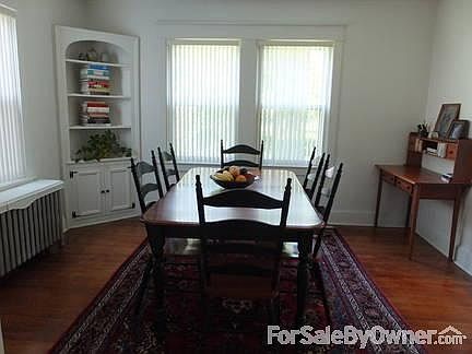 Dining room : Hardwood floors, built in corner cabinet, facing backyard