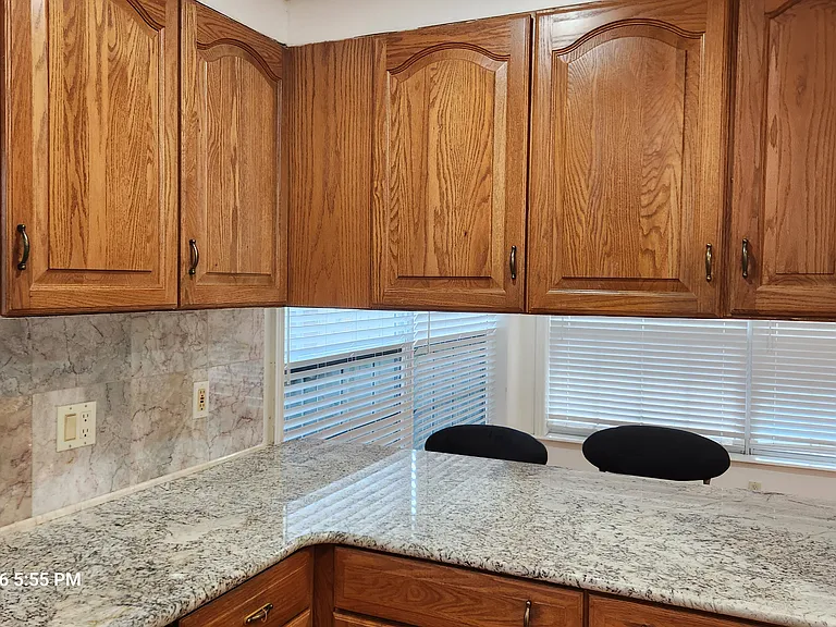 Kitchen with granite countertops and marble backsplash