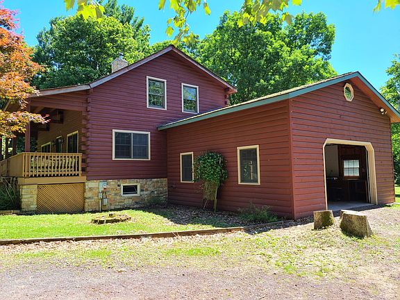 Side view of home...stumps have been removed. New stone in driveway.