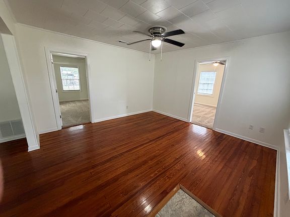 Living area boasts lovely hardwood floors