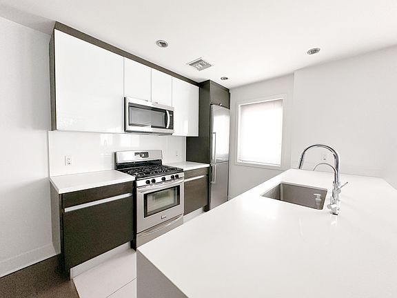 The epitome of an efficient kitchen - quartz, Grohe fixtures, Italian cabinetry, water filtration system, like "new" Bosch fridge, gas range/oven, microwave, dishwasher