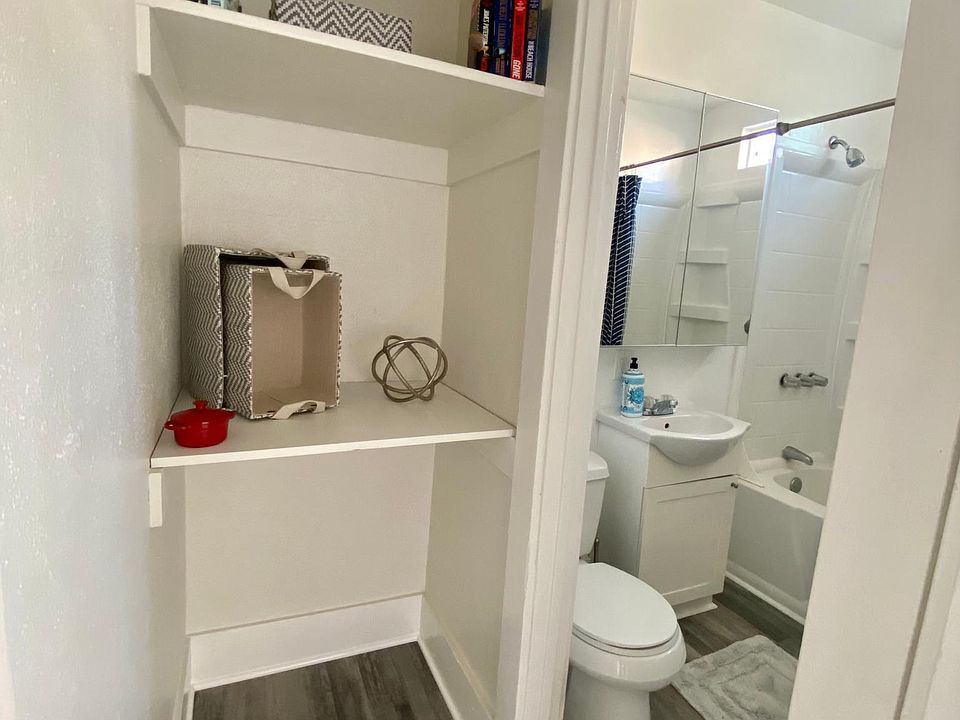 Linen closet and bathroom with high ceilings
