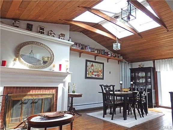 Dining room with skylights and fireplace