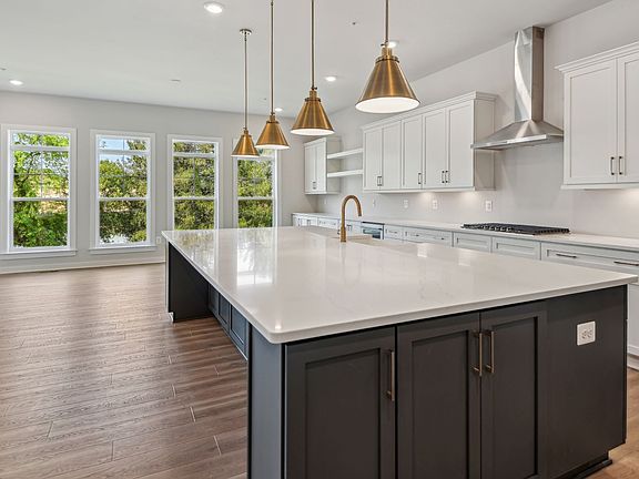 Island Kitchen with stone countertops and upgraded appliances in Creighton Floorplan in Fairway Esta