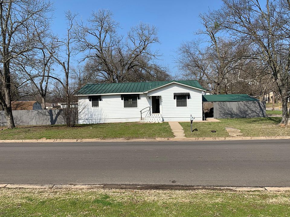 Front view showing carport to the right