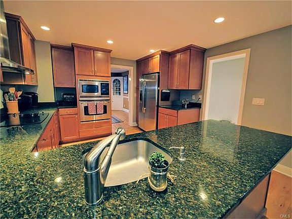 Gleaming granite counters, with shaker style cabinets