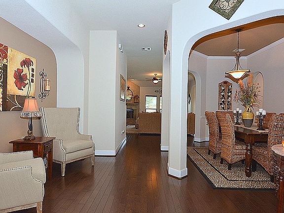 UPON ENTERING THE HOME YOU'RE GREETED BY EXTENSIVE REAL HARDWOOD FLOORS THAT FROM THROUGH THE FOYER,