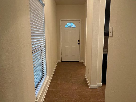 Front Door and Entry Hallway to half-bath and kitchen